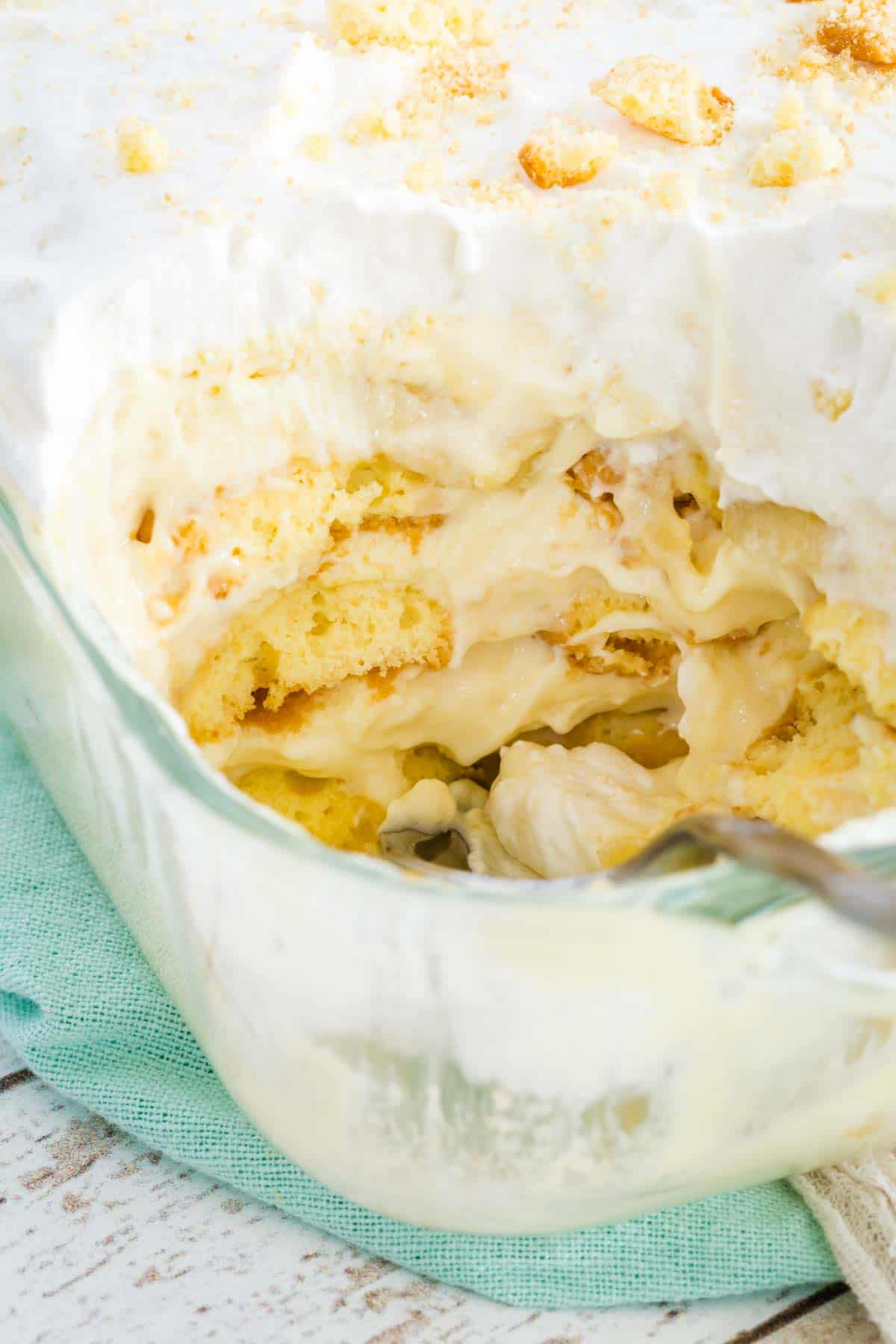 Gluten-free banana pudding in a casserole dish with a serving missing from the corner.