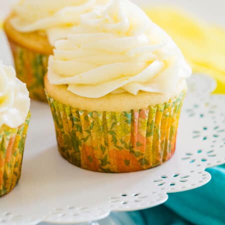 Frosted gluten-free lemon cupcakes on a cupcake stand.