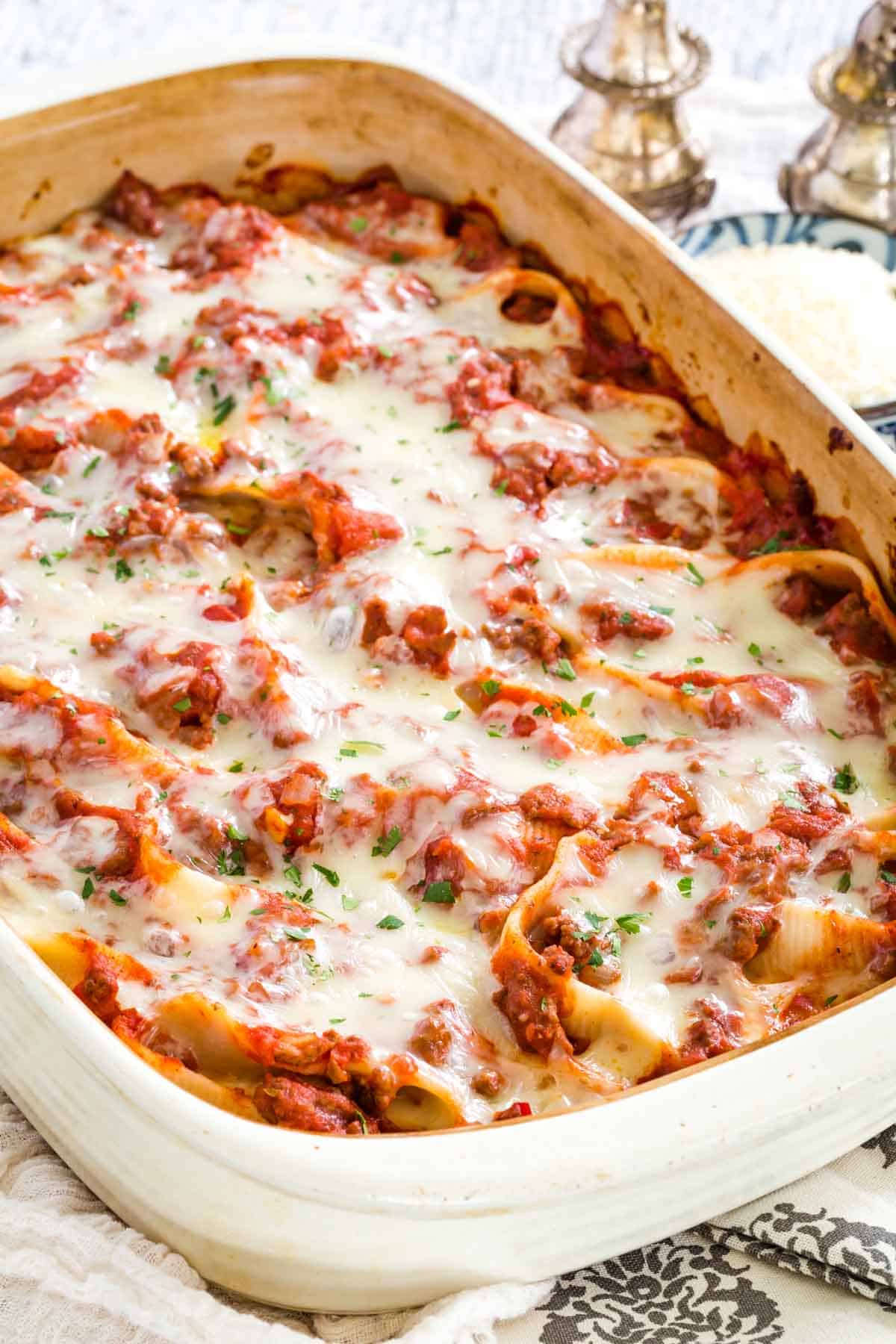 Freshly baked gluten-free stuffed shells in a large casserole dish.