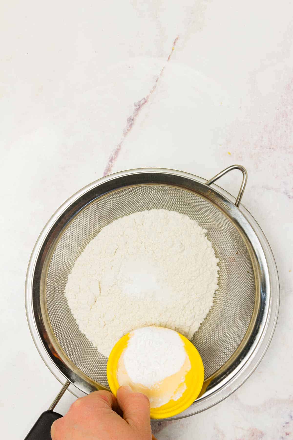 Dry ingredients are passed through a sieve.