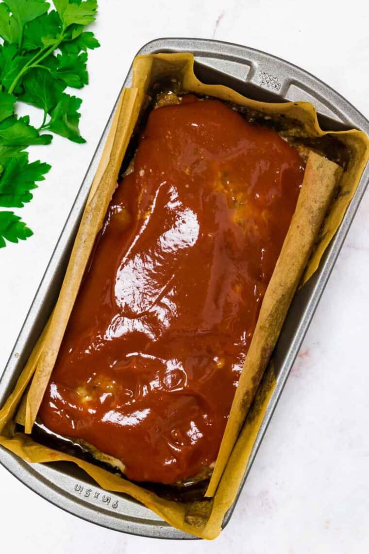 Glazed gluten-free classic meatloaf in a parchment-lined baking pan.