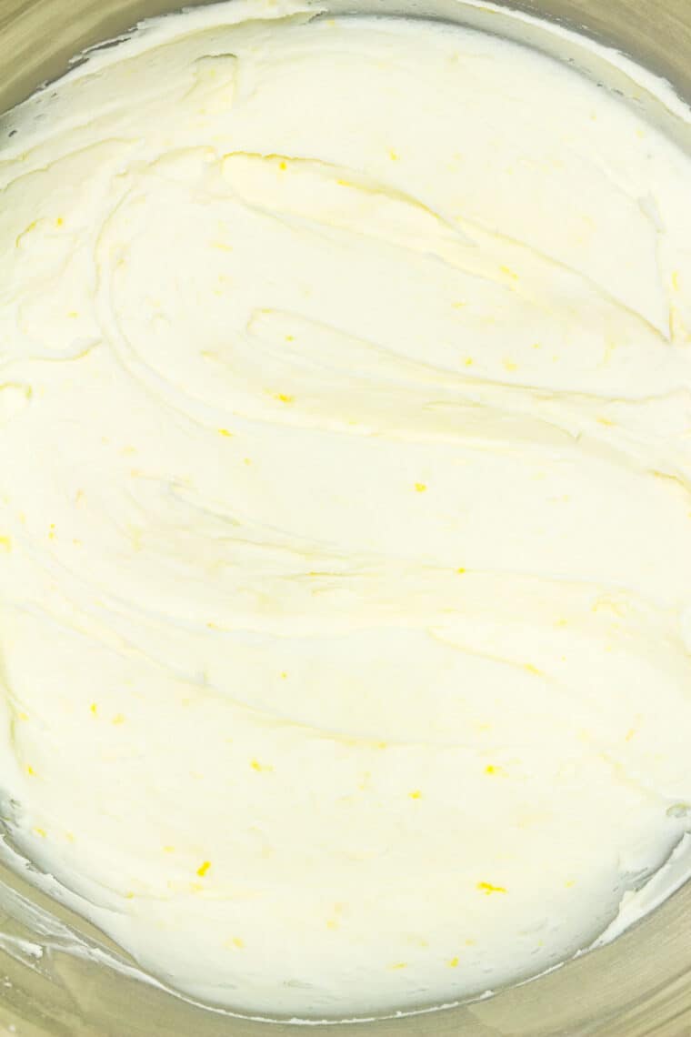 Close up of lemon buttercream frosting in a bowl.