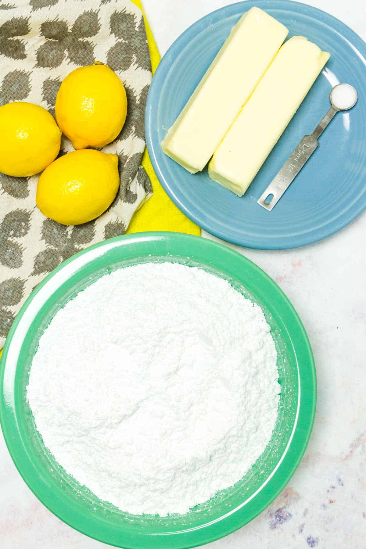 The ingredients for homemade lemon buttercream frosting.