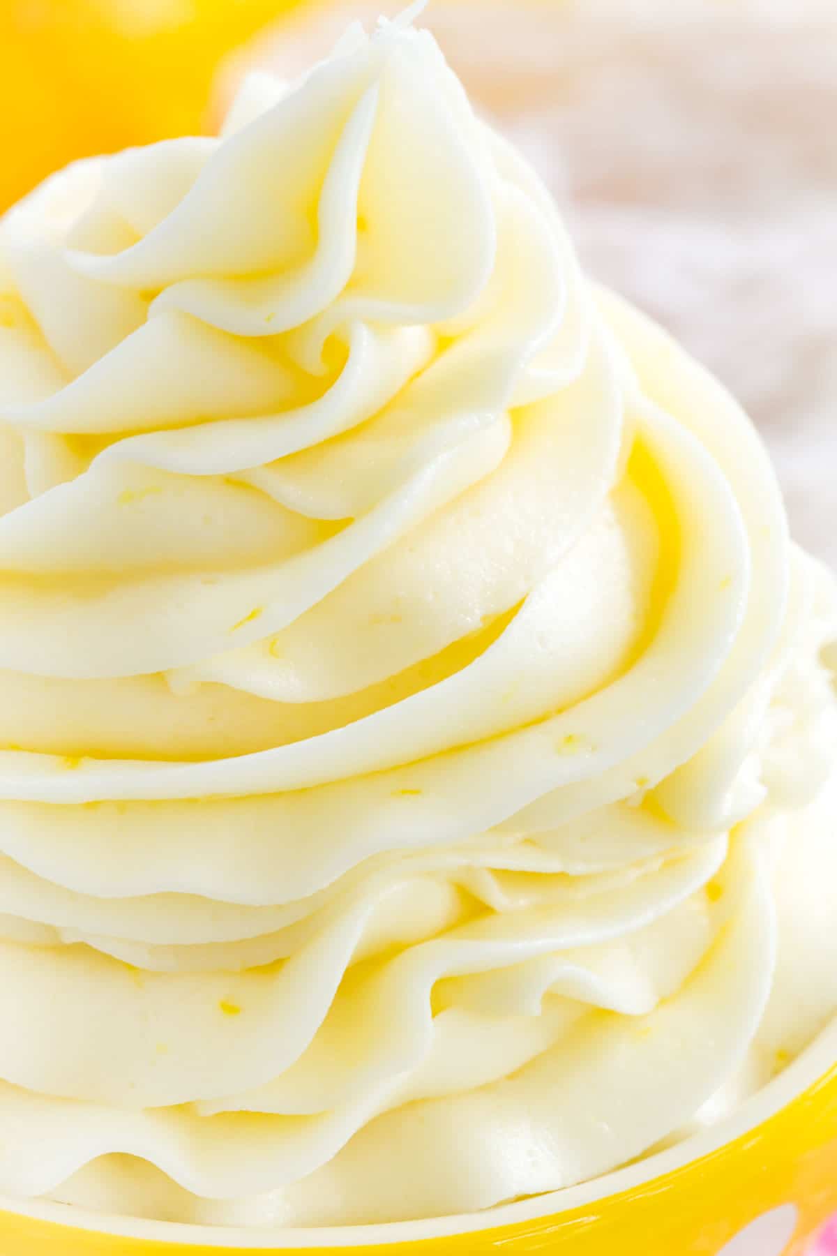 Close up of a swirl of lemon buttercream frosting.