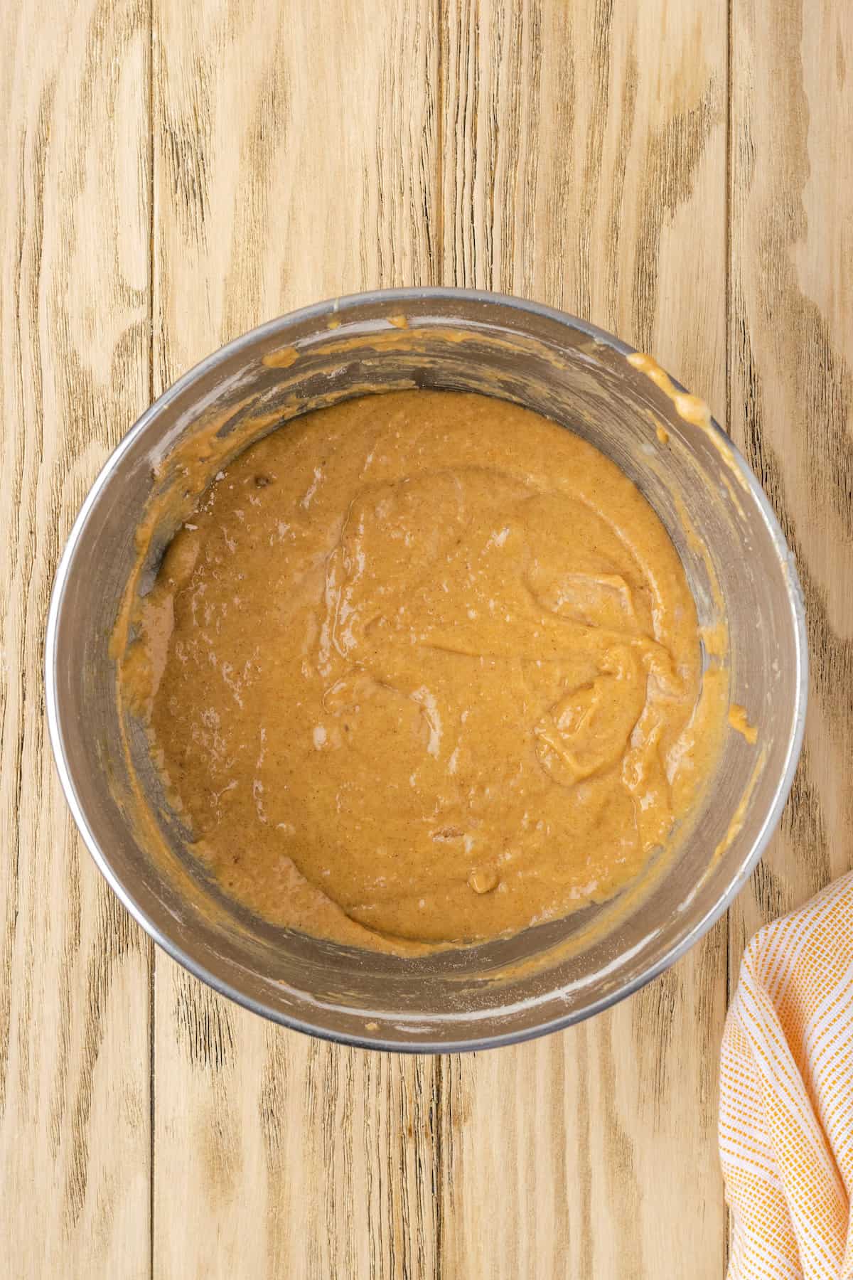 Carrot cake batter in a metal mixing bowl.