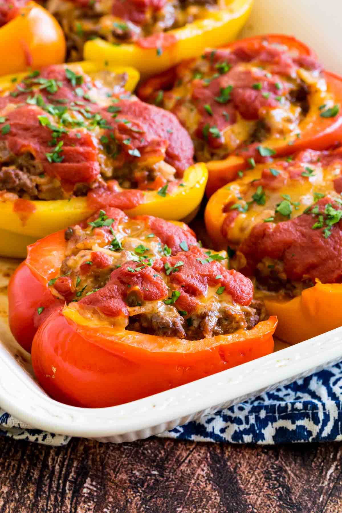 Stuffed peppers in a white ceramic baking dish.