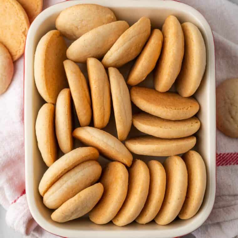 Vanilla wafers packed tightly on their sides in a rectangular dish.