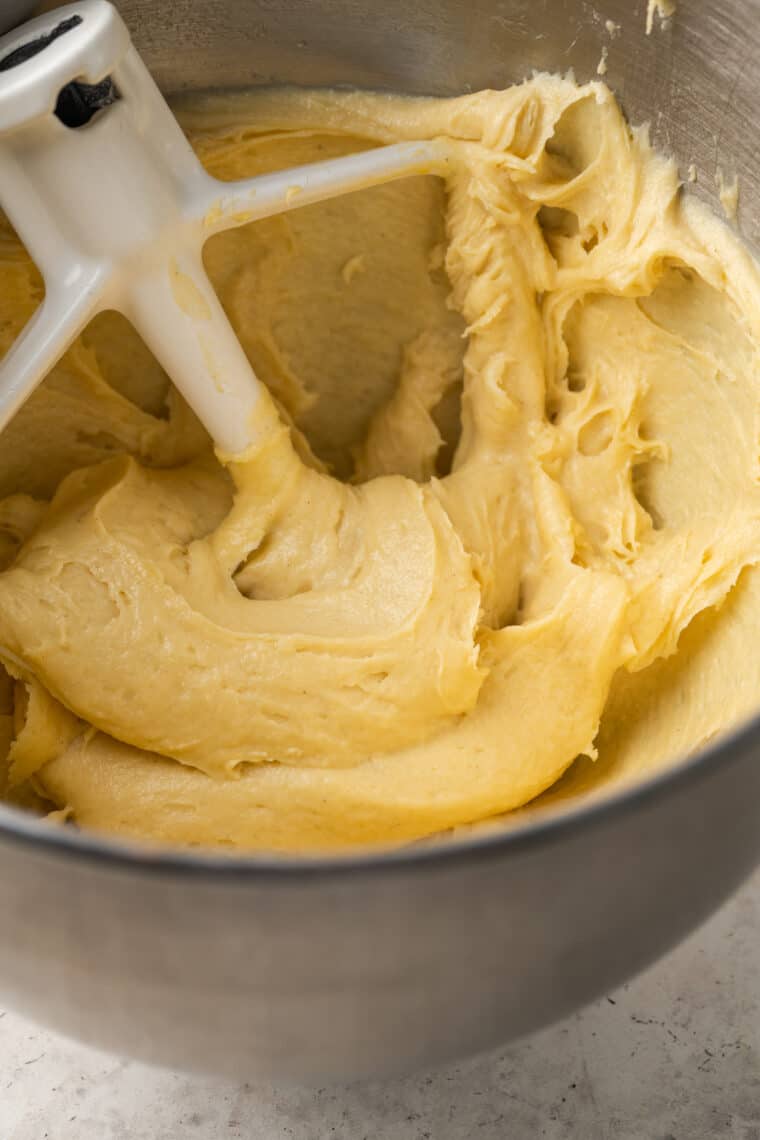 Gluten-free pate a choux dough comes together with a paddle attachment inside a mixing bowl.