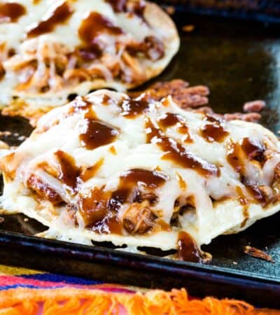 A closeup of one of the Barbecue Chicken Tostadas on a cookie sheet.
