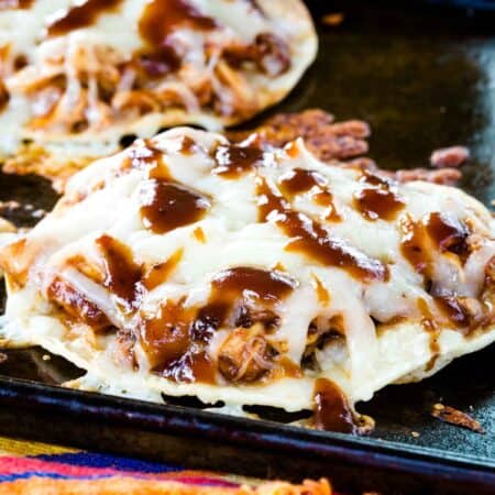 A closeup of one of the Barbecue Chicken Tostadas on a cookie sheet.