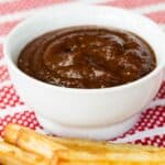 A bowl of ketchup with fries in front of it with text overlay that says "Balsamic Ketchup".