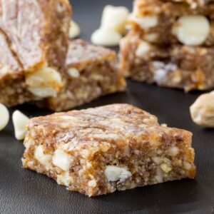 A banana energy bar in the foreground with a stack of bars in the background.