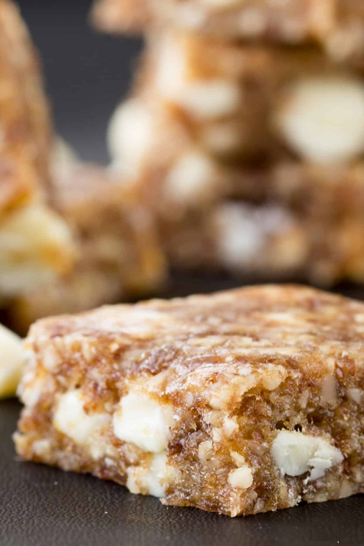 A closeup of a banana energy bar with white chocolate chips.