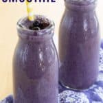 Two purple-colored smoothies in glass bottles with text overlay that says "Blueberry Smoothie".