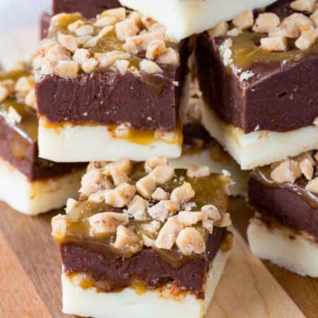 A pile of pieces of Caramel Toffee Fudge on a cutting board.