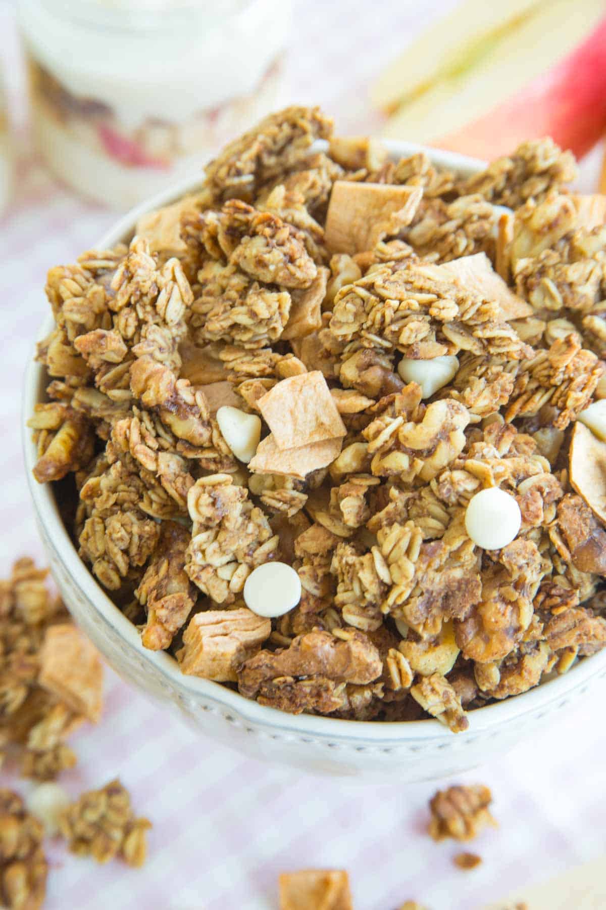 An overflowing bowl of apple cinnamon granola.