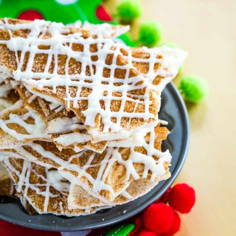 Pieces of Cinnamon-Sugar White Chocolate Bark stacked in a small metal dish.