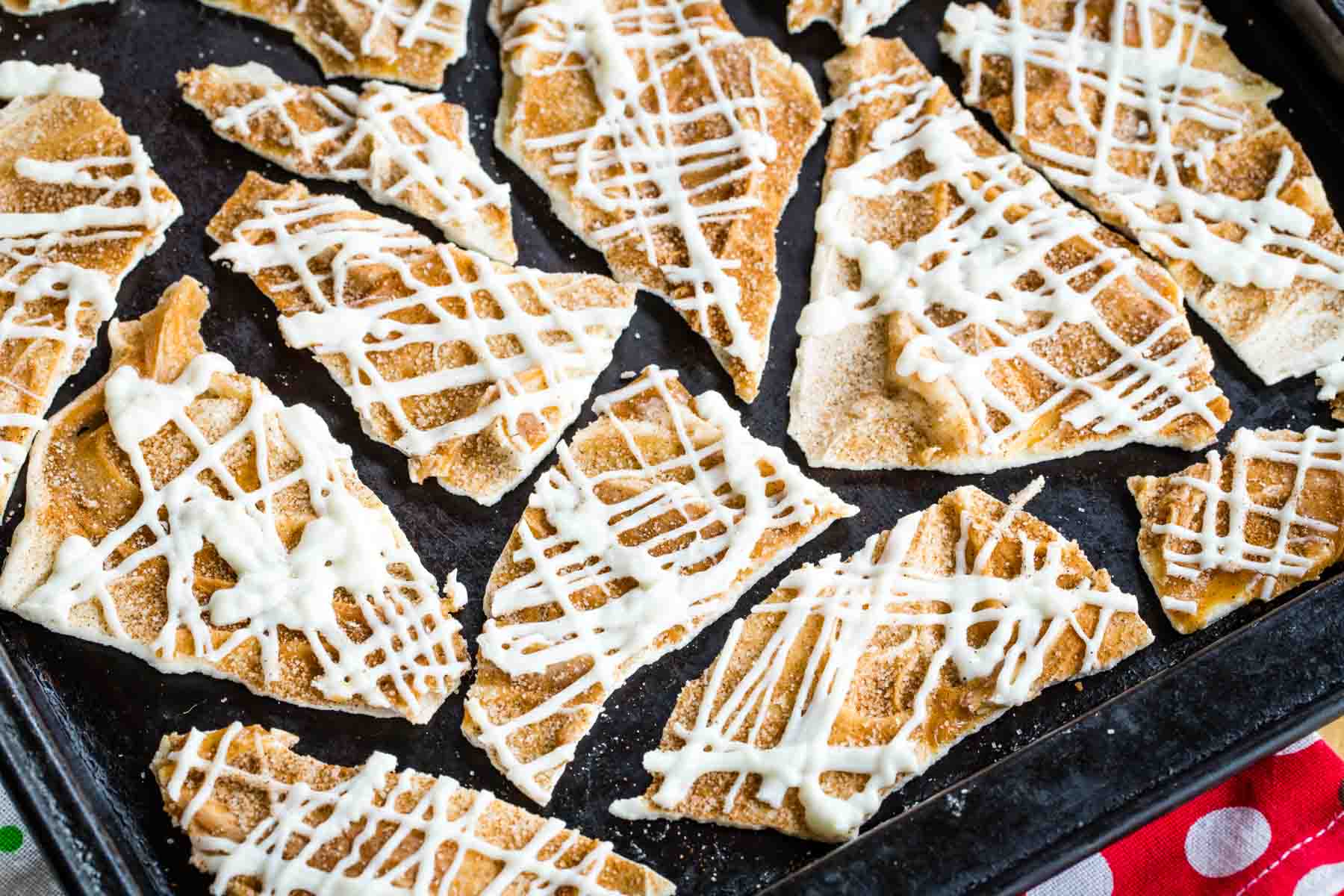 Pieces of Cinnamon-Sugar White Chocolate Bark on a cookie sheet.