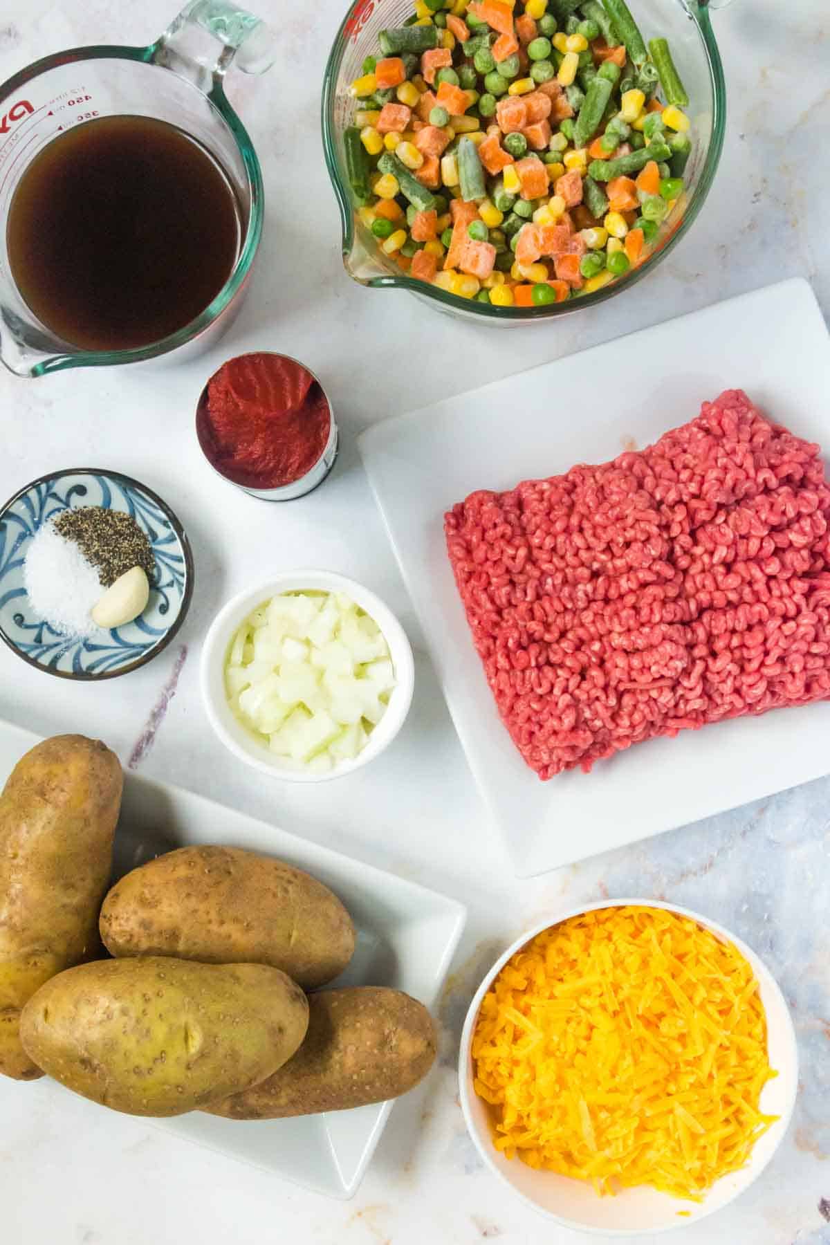 Bowls and plates of ingredients to make cottage pie baked potatoes.