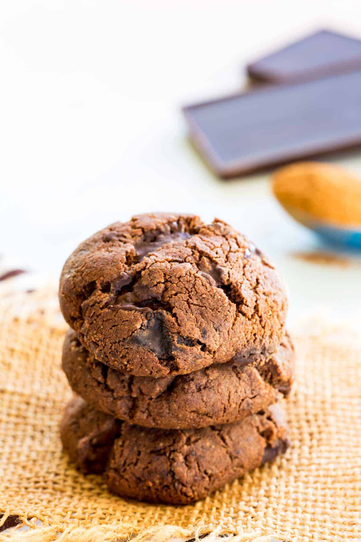 A stack of three Mexican hot chocolate cookies on a piece of burlap.