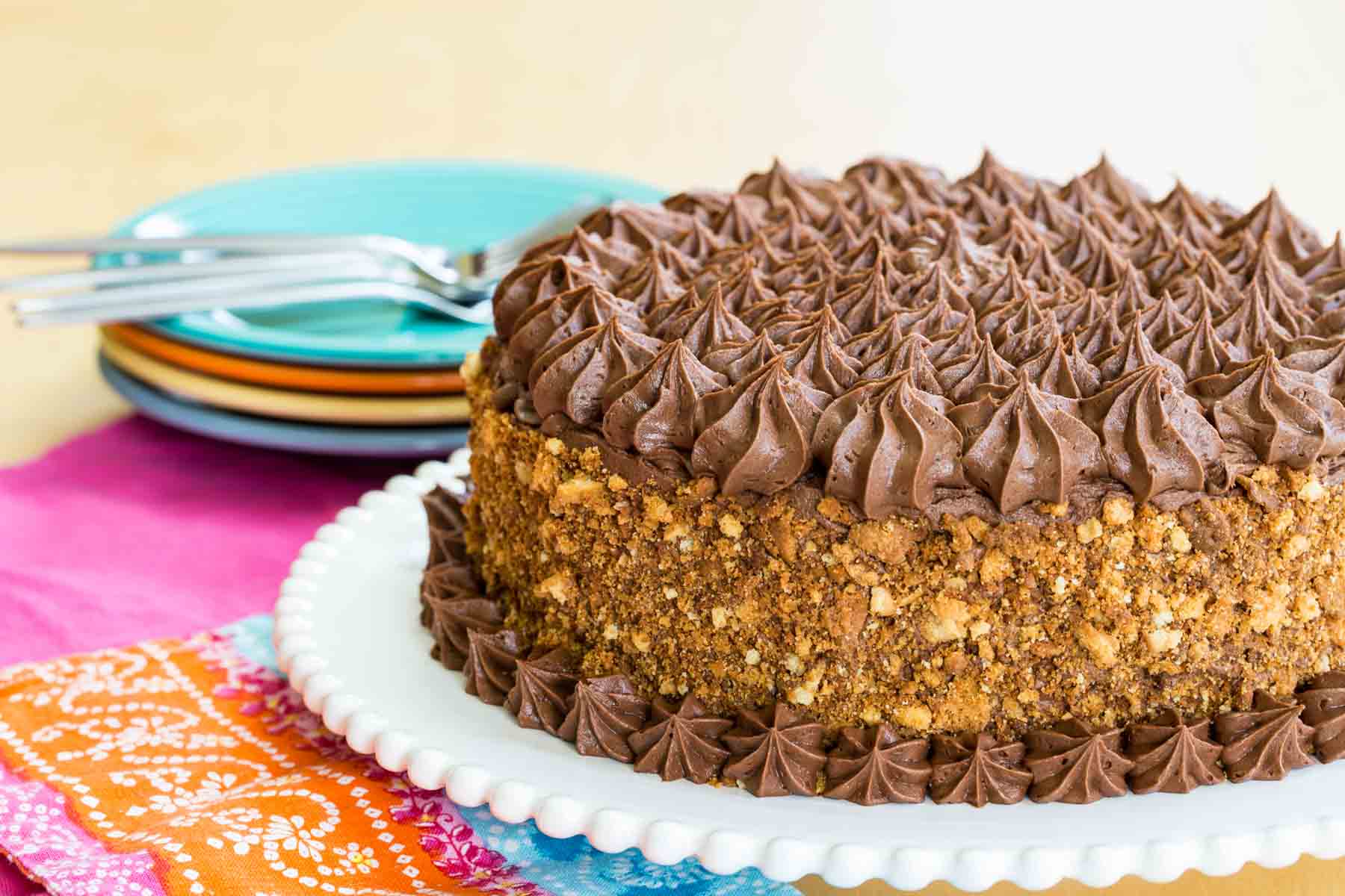 A whole gluten free layer cake with chocolate buttercream and yellow butter cake crumbs.