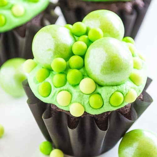 A Halloween cupcake decorated with green frosting and decorations.