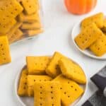 rectangluar gluten free pumpkin cookies on plates and in a jar with a black and white checked cloth napkin.