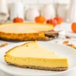 A slice of pumpkin tart on a white plate with the rest of the tart behind it with text overlay that says "Gluten Free Pumpkin Tart".