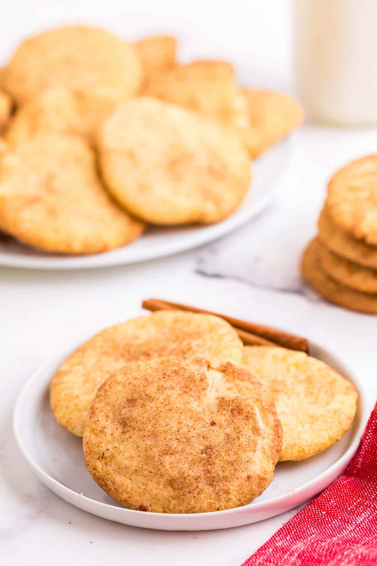 Three gluten free snickdoodles on a white plate.