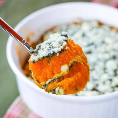 A spoonful of layered butternut squash casserole with steam rising off of it.