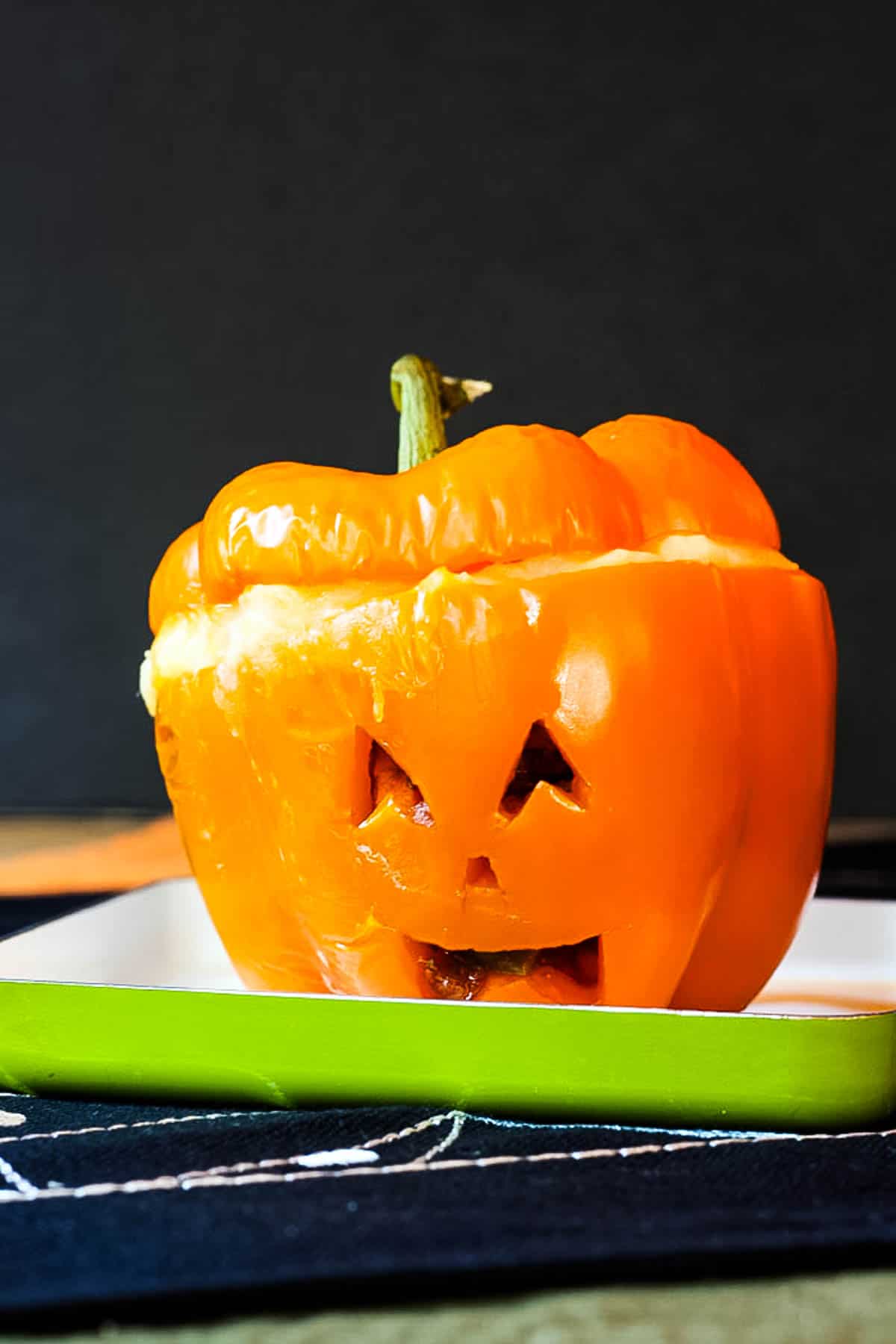 One stuffed pepper carved with a jack o'lantern face.