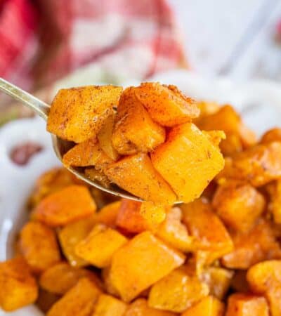 A spoonful of roasted butternut squash with cinnamon flecks.