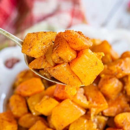 A spoonful of roasted butternut squash with cinnamon flecks.