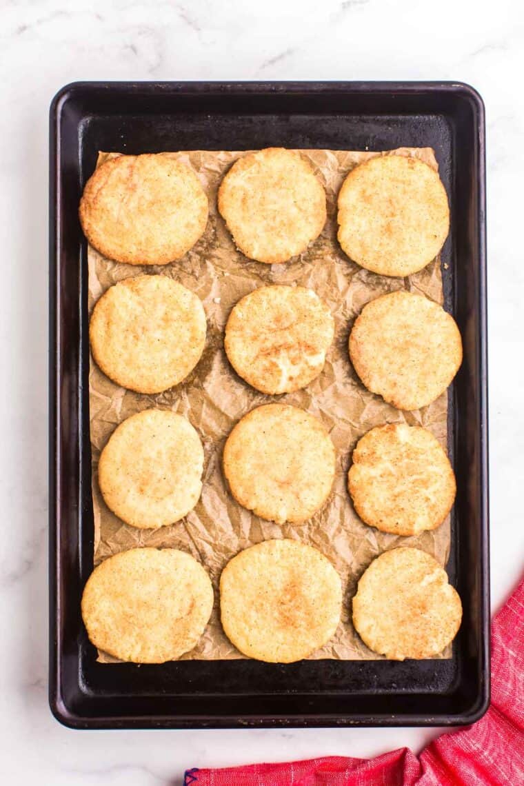 A sheet pan of baked snickerdoodle cookies.