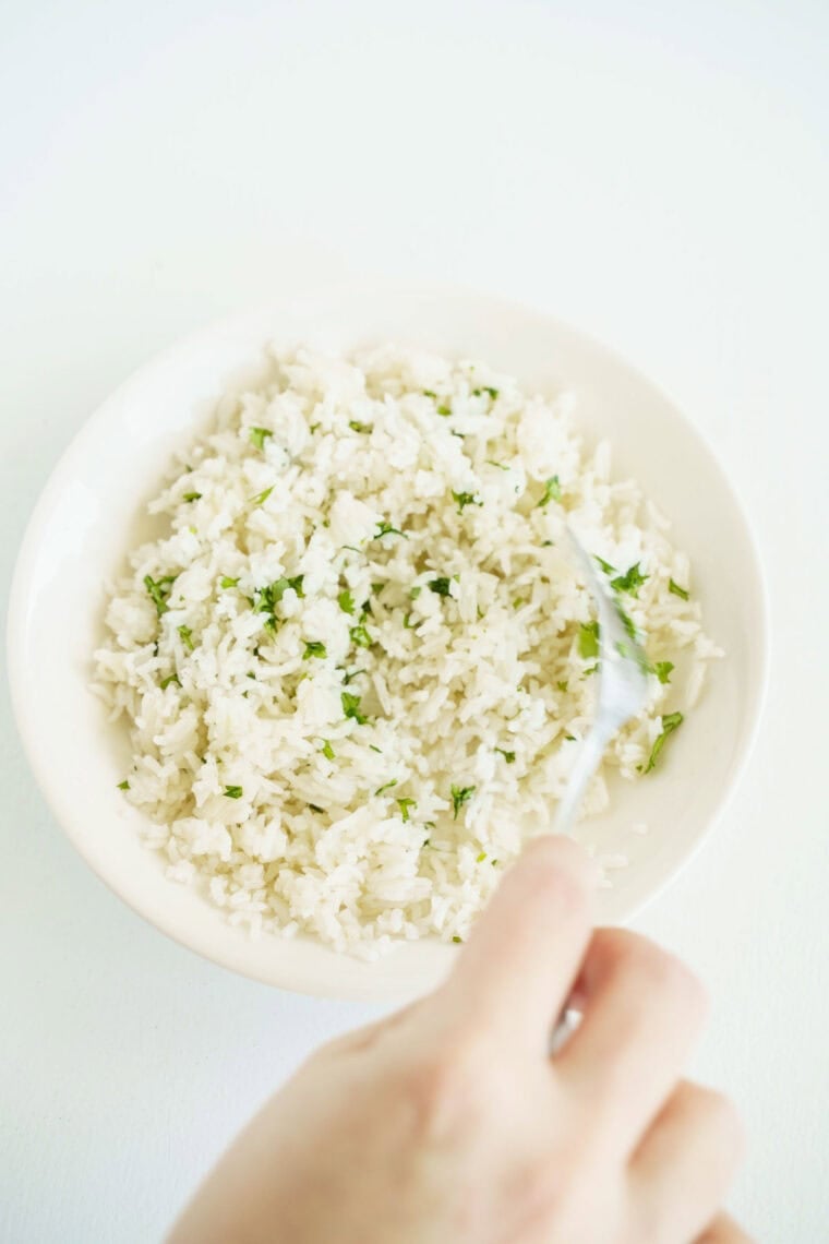 stirring rice with cilantro and lime