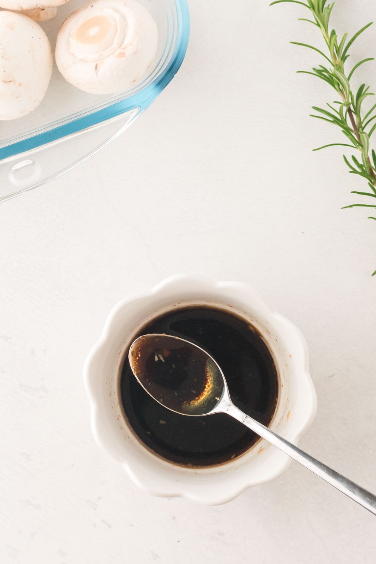 A small bowl with garlic and balsamic vinegar marinade.