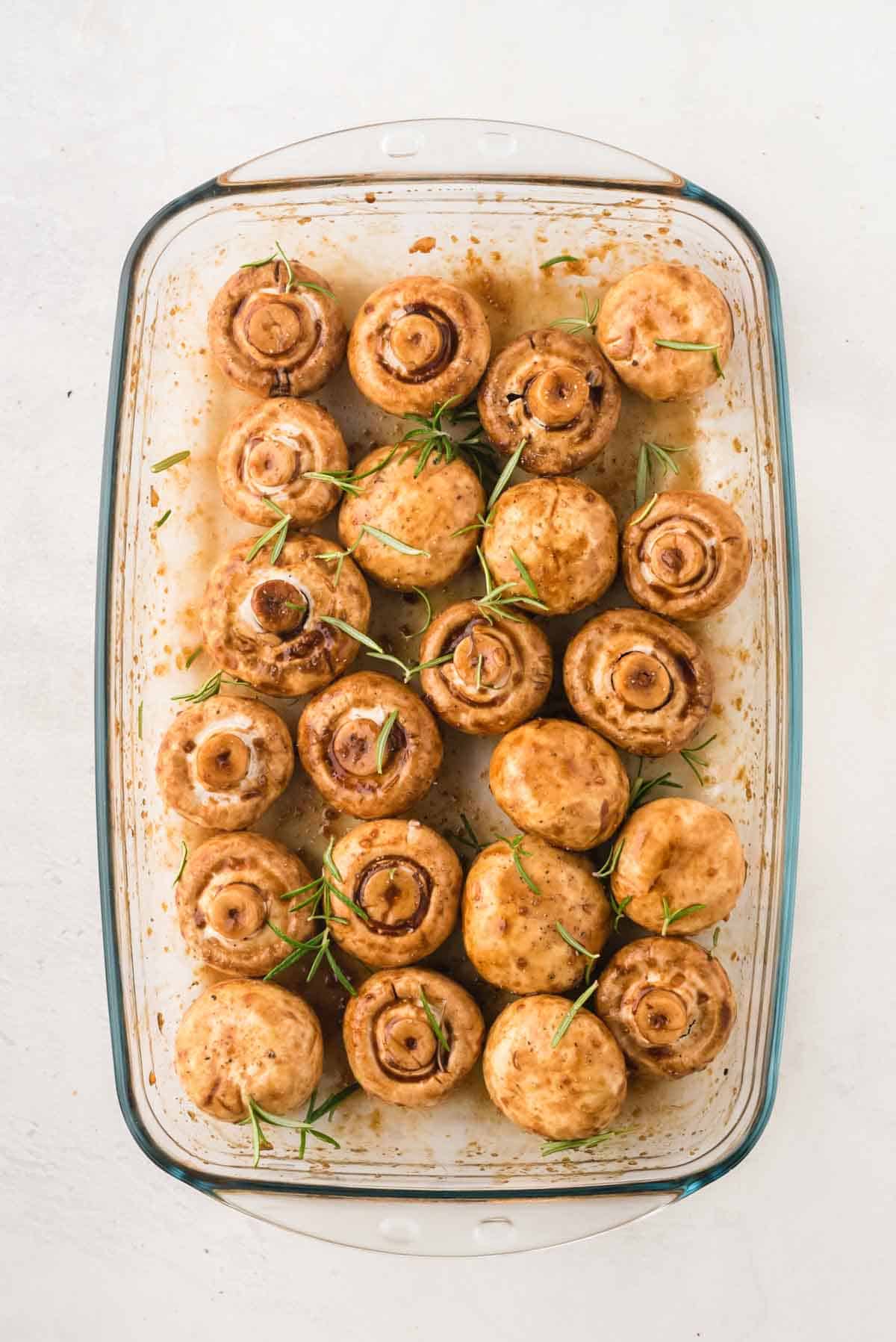 Marinated mushrooms sprinkled with rosemary leaves