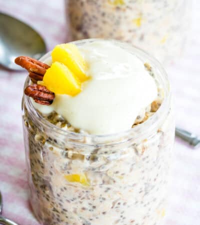 A jar of overnight oats with a spoon next to it.