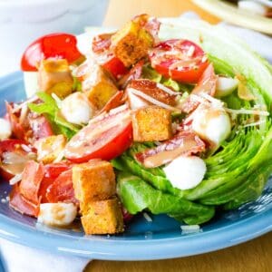 An Italian Wedge Salad on a blue plate.
