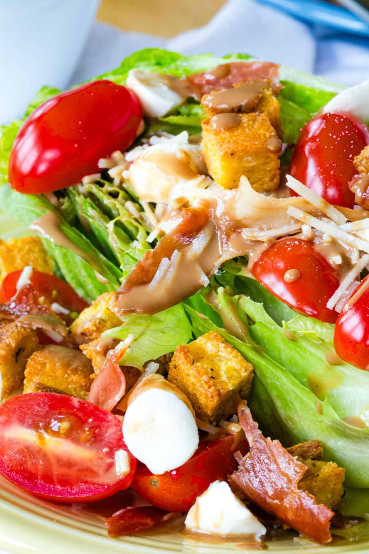A closeup of a romaine heart with lots of salad toppings.