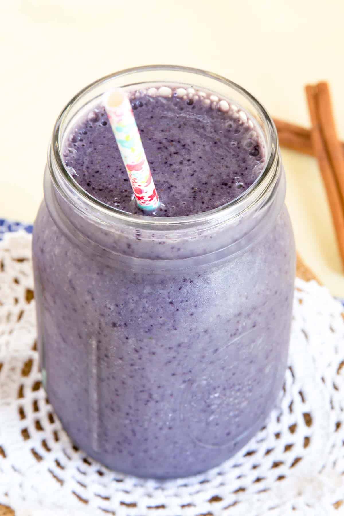 A closeup of the Maple Cinnamon Blueberry Smoothie in a Mason jar.