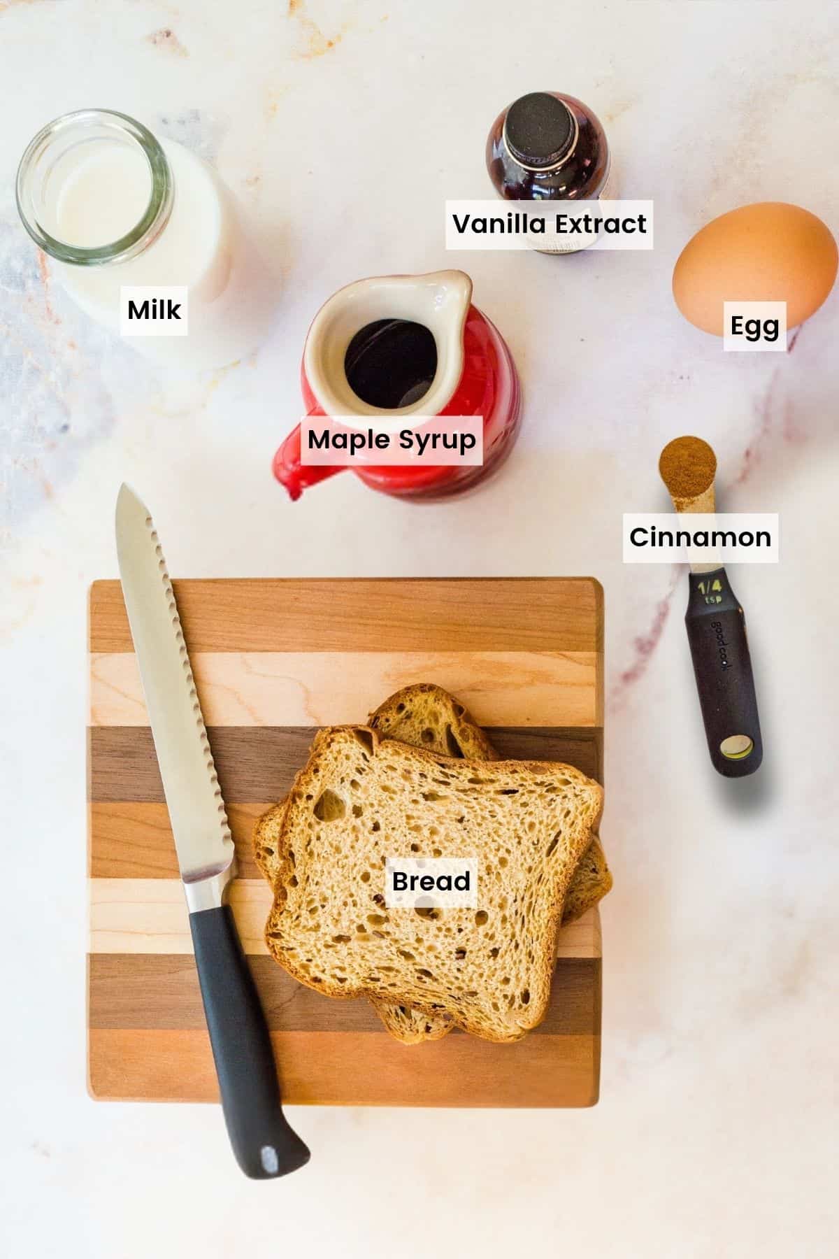 Overhead photo of Bread, Milk, Egg, Maple Syrup, Vanilla, and Cinnamon with text labels.