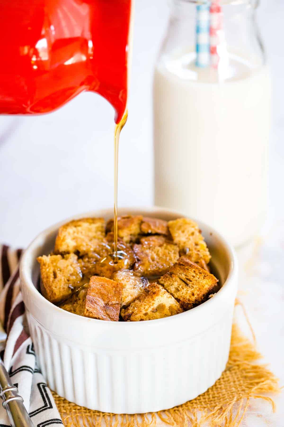 Pouring maple syrup on a French Toast Casserole for One.