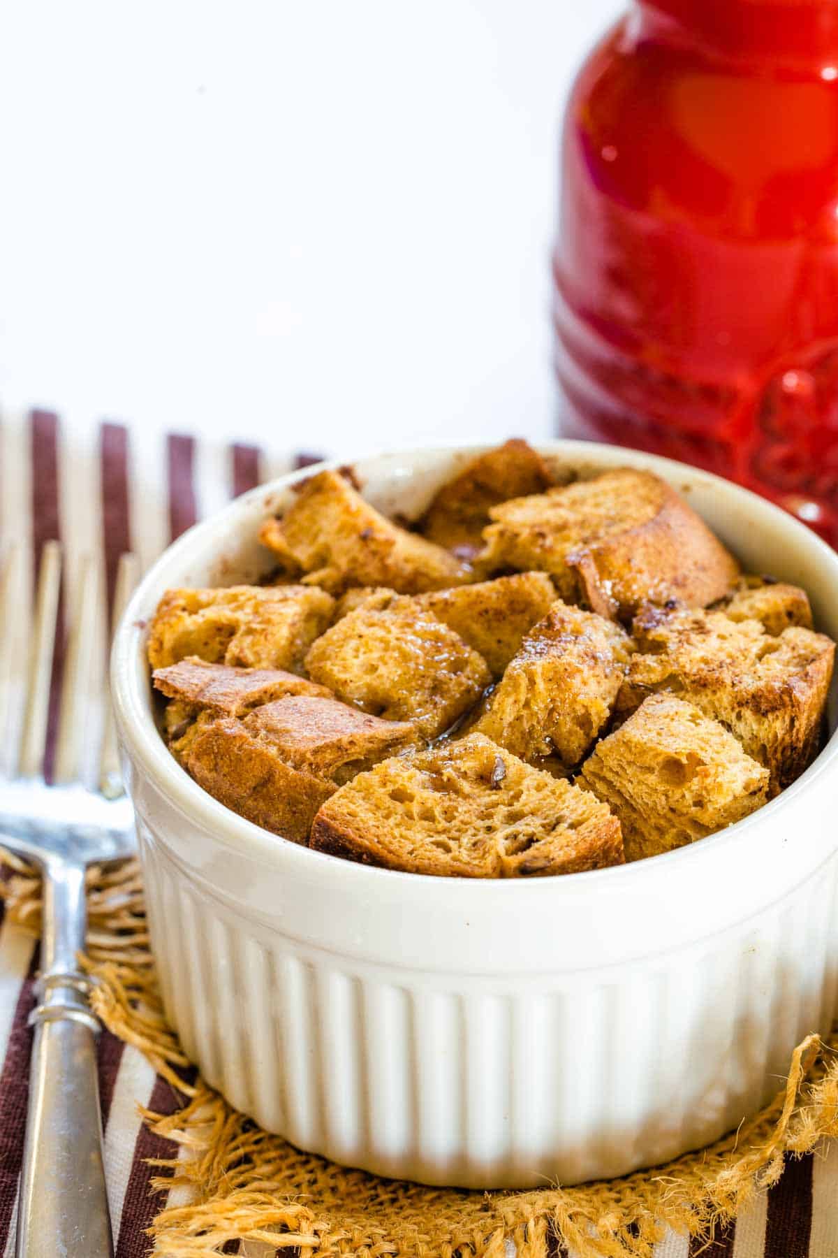 Closeup of a mini Gluten Free French Toast Casserole with a fork and milk to drink.