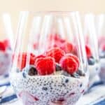 Chia pudding with berries in a glass with text overlay that says "Mixed Berry Chia Pudding".