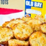 A plate of cauliflower tots with a tin of Old Bay Seasoning behind it with text overlay that says "Old Bay Cauliflower Tots".