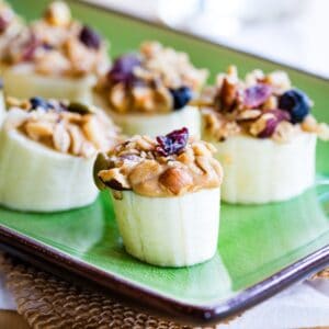 Peanut butter banana snacks lined up on a green plate.