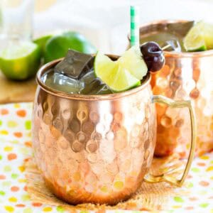 A pina colada moscow mule cocktail in a copper mug with a straw.