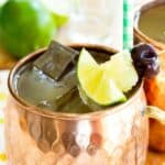 A cocktail in a copper mug with text overlay that says "Pina Colada Moscow Mule".