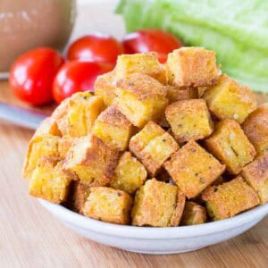 Parmesan Polenta Croutons piled in a small dish.